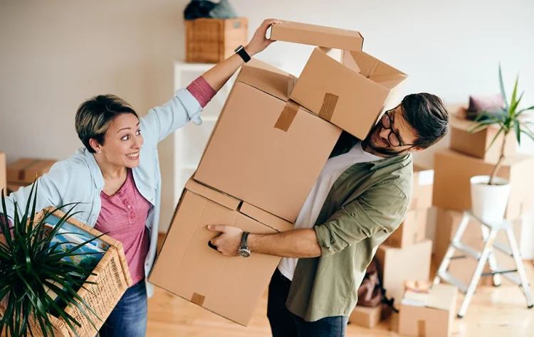 Person balancing stacked boxes Person Moving House